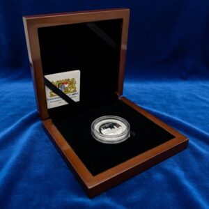 Braunes Etui, geöffnet, blauer Samt als Hintergrund. Im Etui liegt ein eingekapselter Bayern Thaler in Silber.